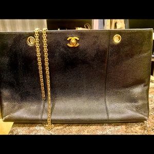 Large CHANEL black leather, gold chain strap.